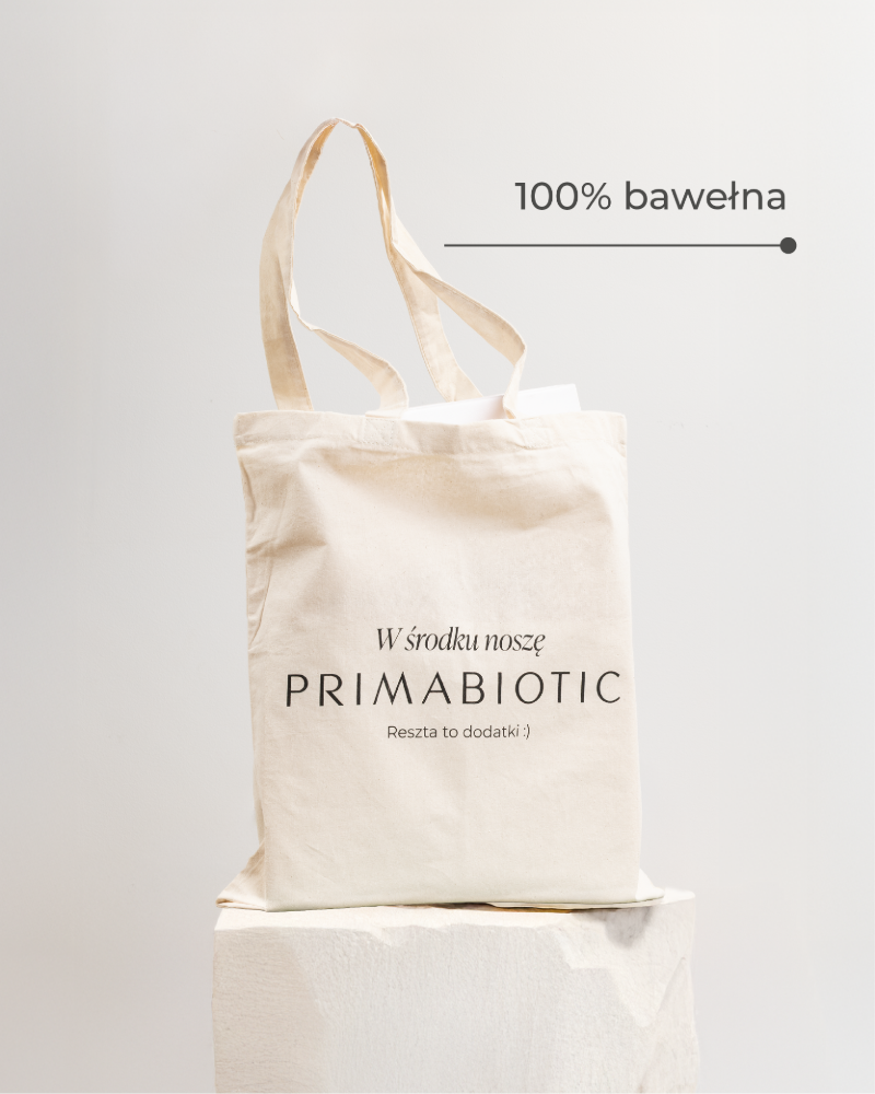 Torba bawełniana Primabiotic 100% bawełna z napisem „W środku noszę Primabiotic” ustawiona na podstawce